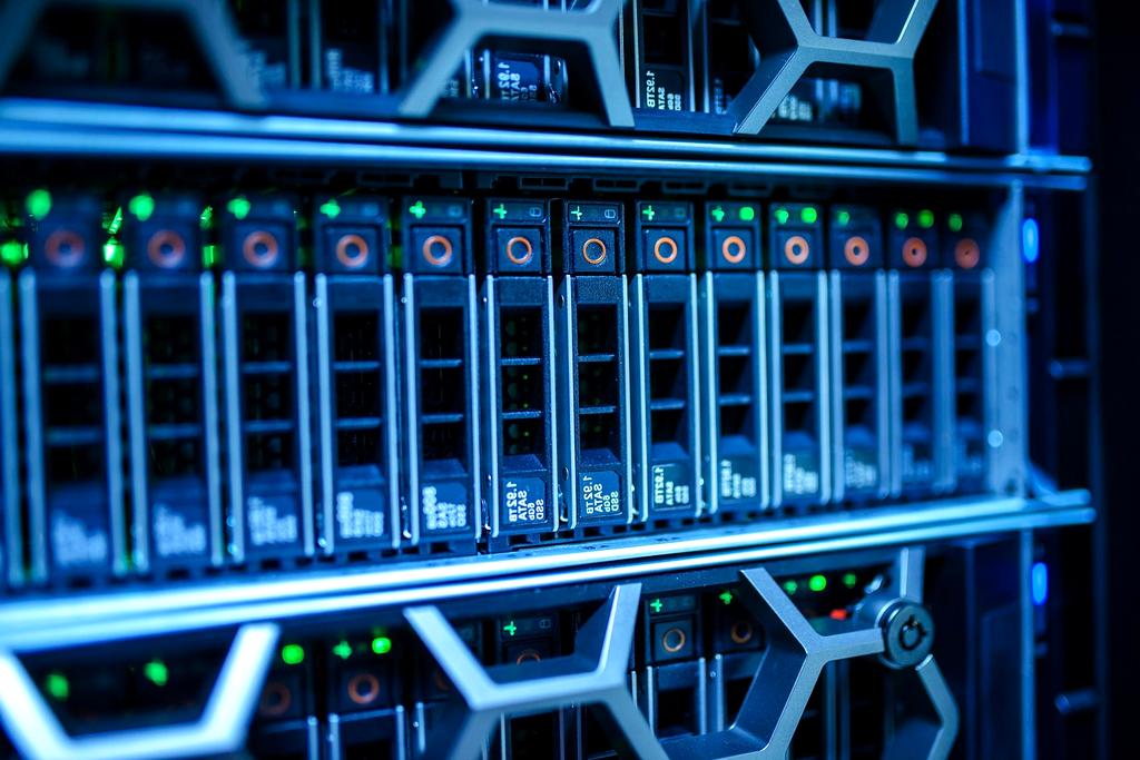 Engineers analyzing data on multiple screens in a modern server room